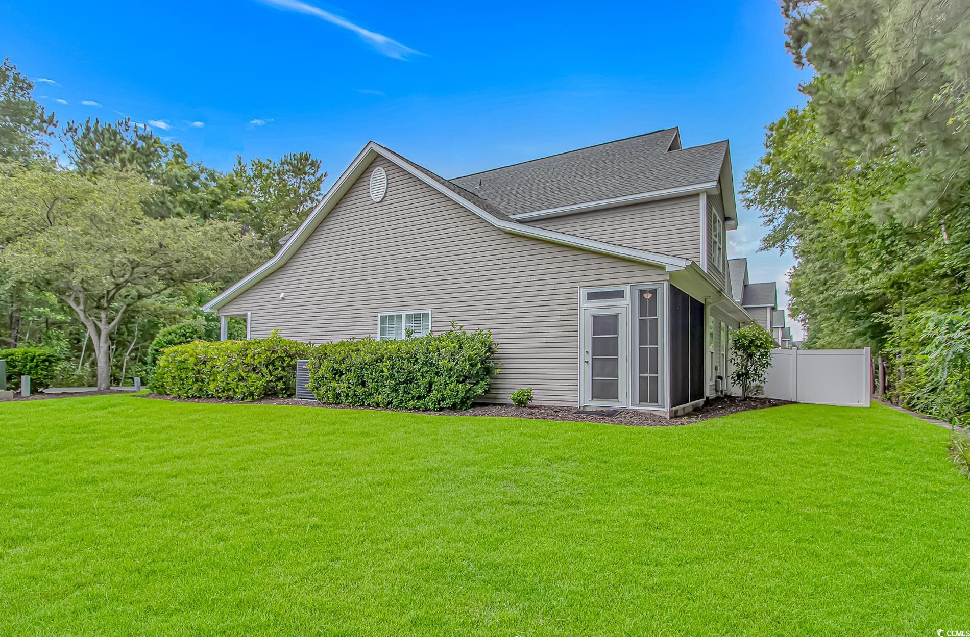 751 Painted Bunting Drive, Unit E Murrells Inlet, SC 29576 - Photo 37 of 40 View of property exterior featuring a shingled roof