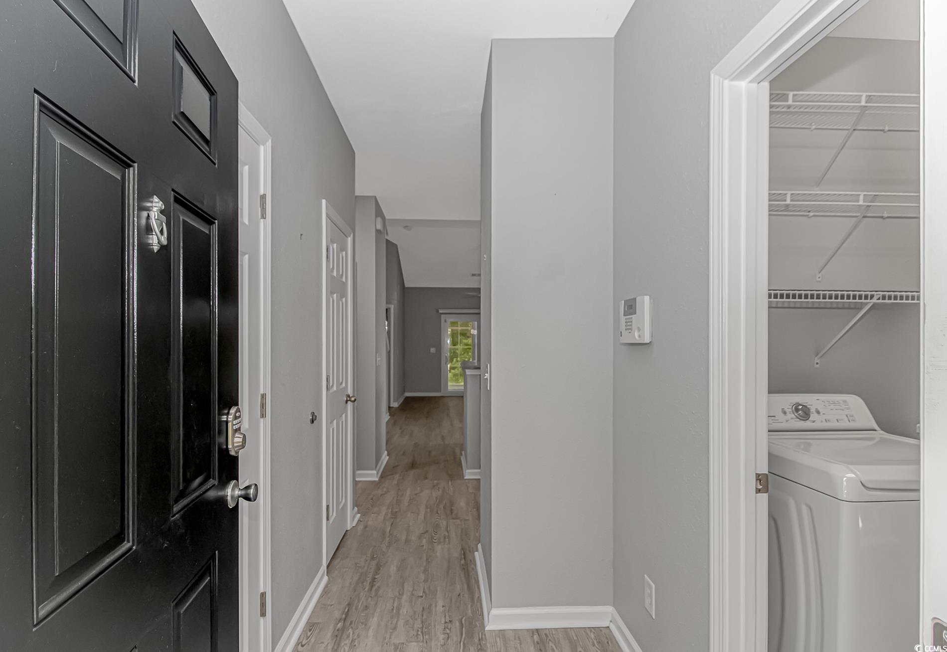 751 Painted Bunting Drive, Unit E Murrells Inlet, SC 29576 - Photo 5 of 40 Laundry area with washer / clothes dryer, light wood-type flooring, and baseboards