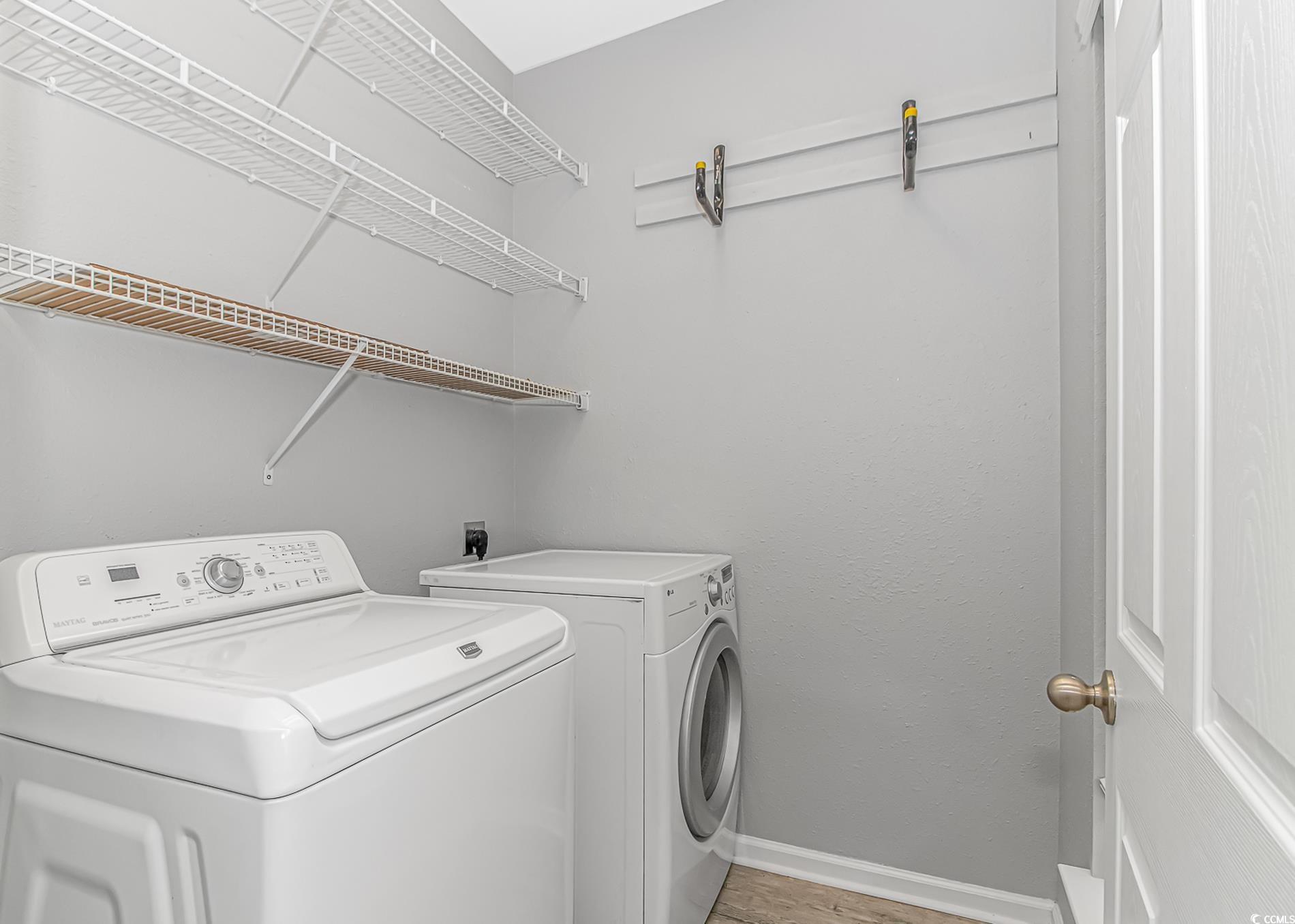 751 Painted Bunting Drive, Unit E Murrells Inlet, SC 29576 - Photo 6 of 40 Laundry area featuring washing machine and clothes dryer, baseboards, and light wood-type flooring