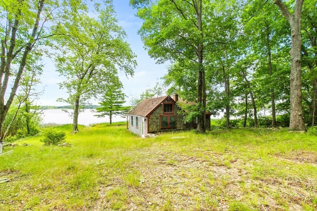 405 Neck Road Rochester, MA 02770 - Photo 4 of 36 a tall house with a big yard