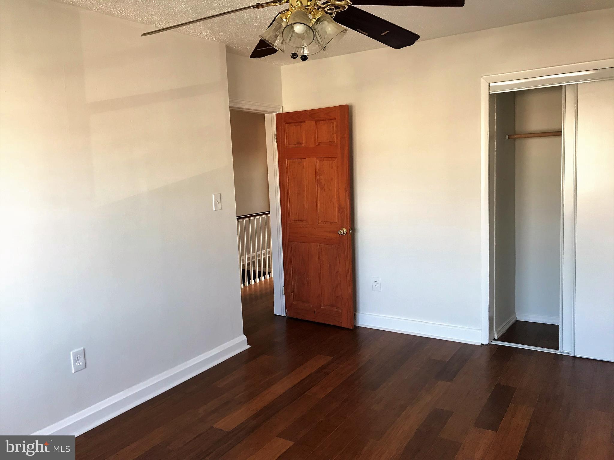 1905 Barry Road Dundalk, MD 21222 - Photo 11 of 23 an empty room with wooden floor closet and windows