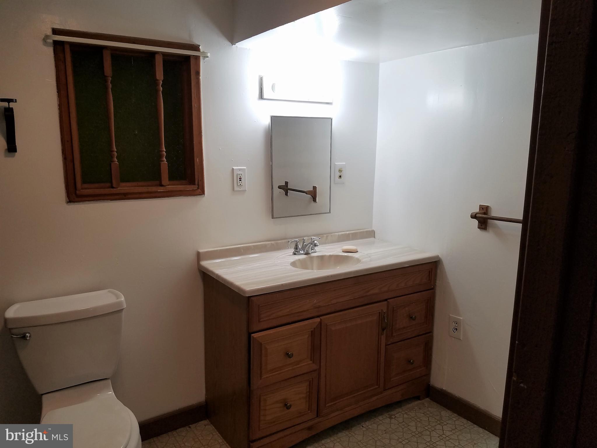 1905 Barry Road Dundalk, MD 21222 - Photo 18 of 23 a bathroom with a toilet sink and mirror