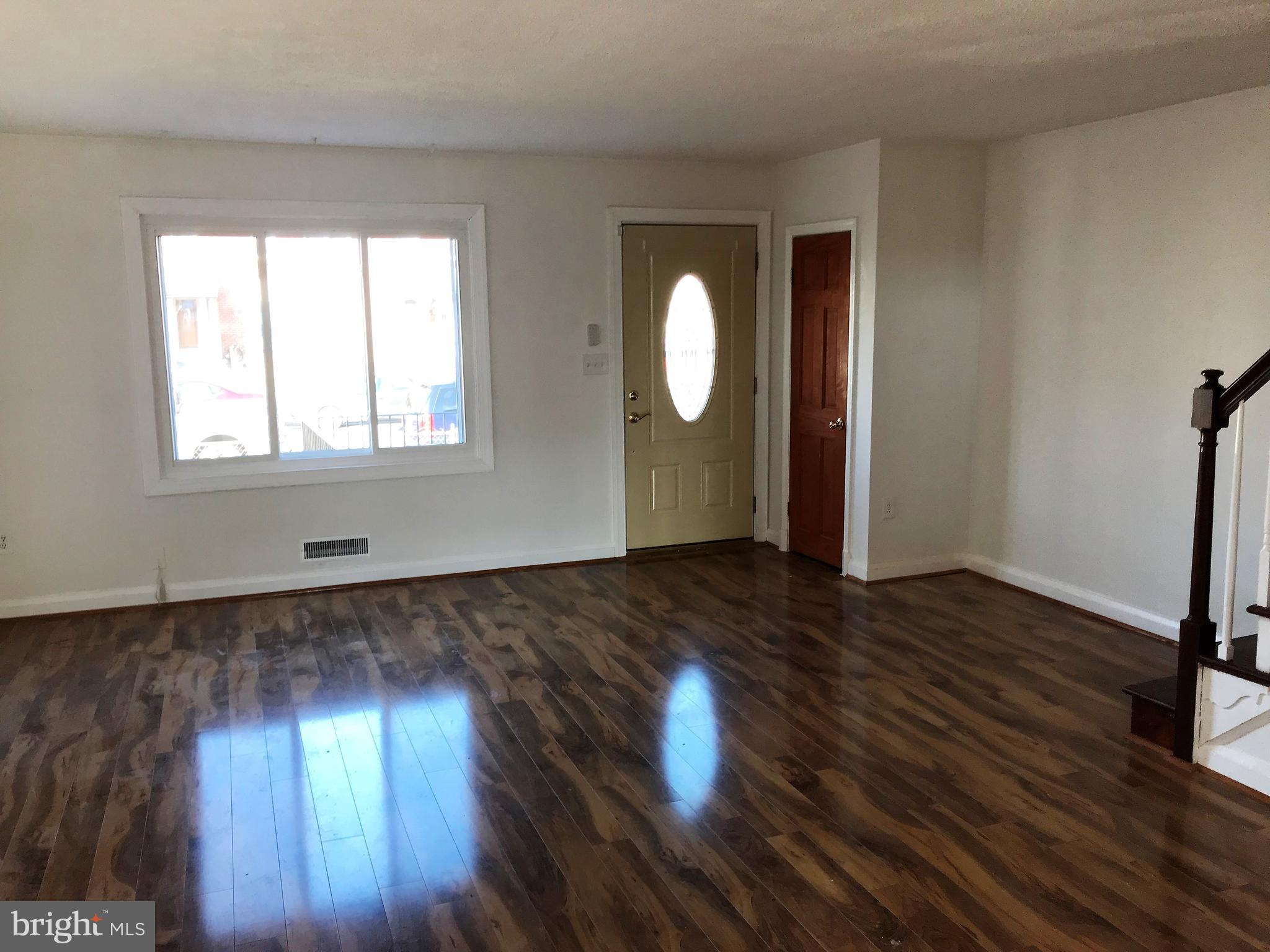 1905 Barry Road Dundalk, MD 21222 - Photo 3 of 23 an empty room with wooden floor and windows