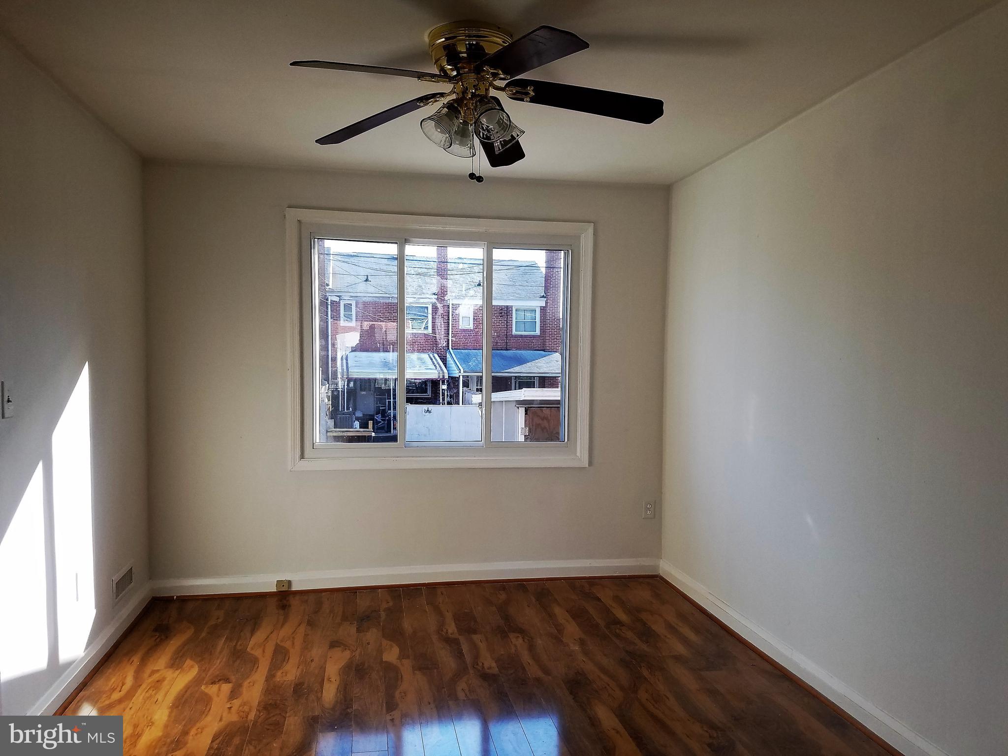 1905 Barry Road Dundalk, MD 21222 - Photo 4 of 23 a view of empty room with wooden floor and fan