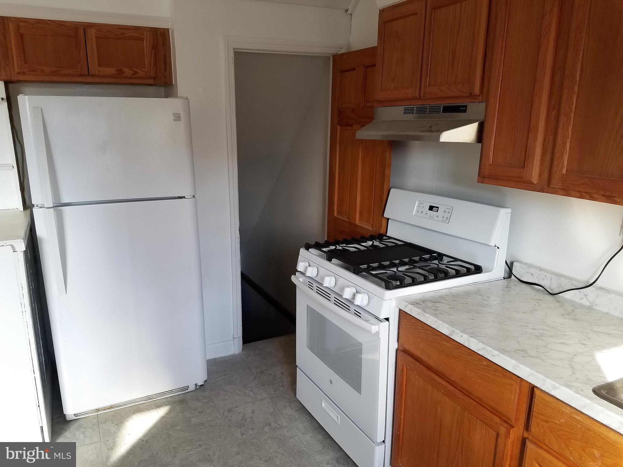 1905 Barry Road Dundalk, MD 21222 - Photo 6 of 23 a kitchen with a stove and a refrigerator