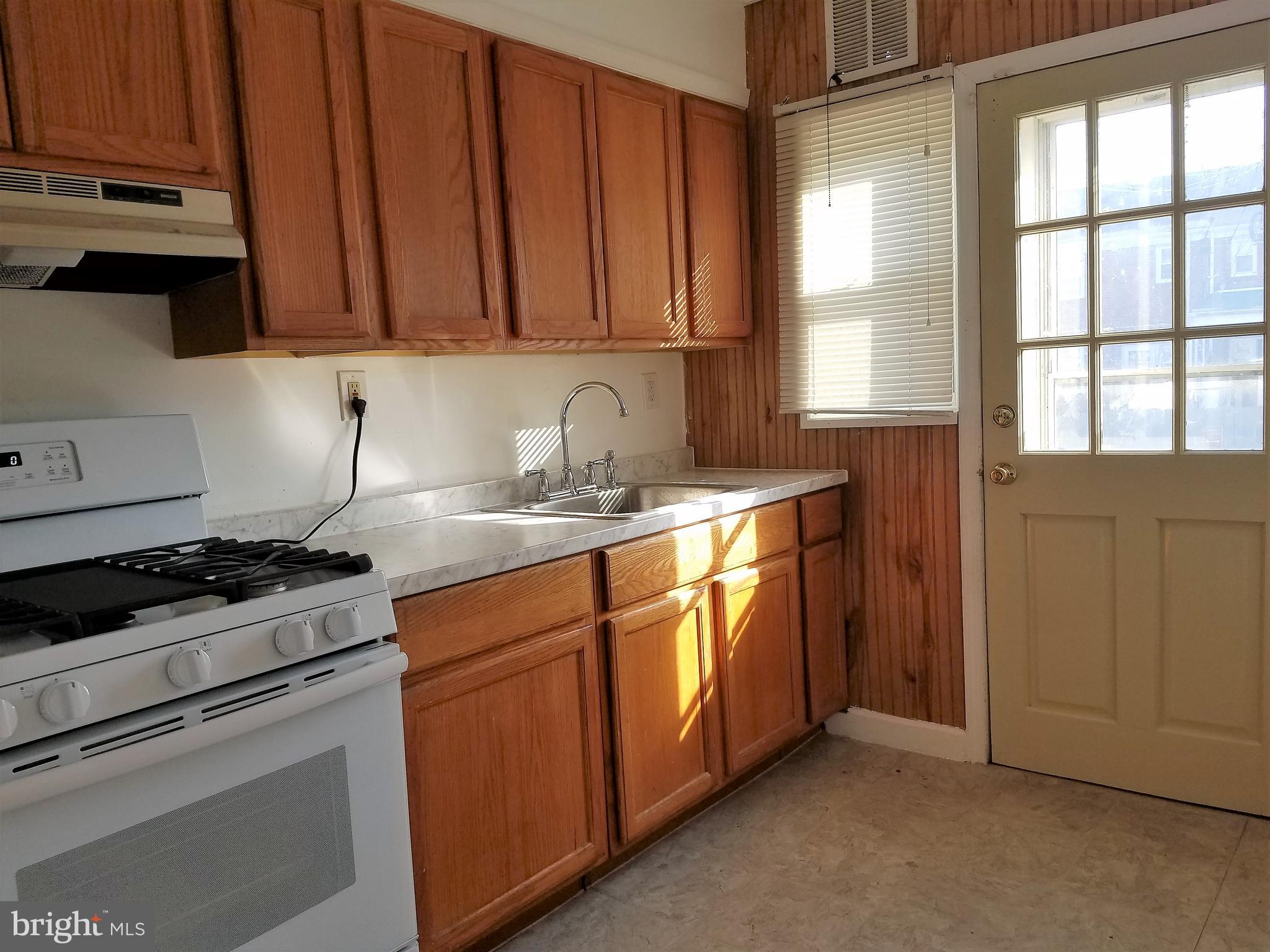 1905 Barry Road Dundalk, MD 21222 - Photo 7 of 23 a kitchen with stainless steel appliances granite countertop a sink stove and cabinets