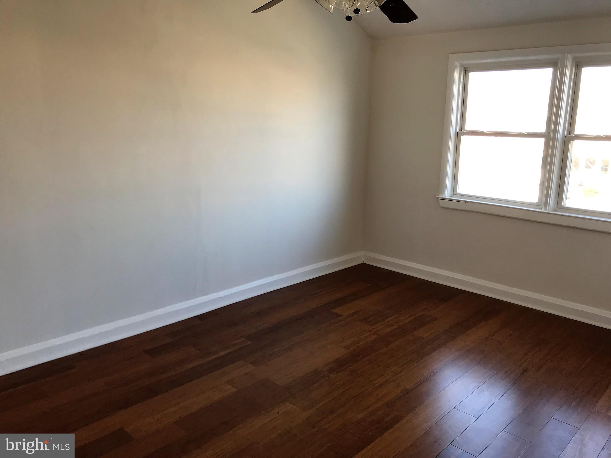 1905 Barry Road Dundalk, MD 21222 - Photo 10 of 23 wooden floor in an empty room with a window