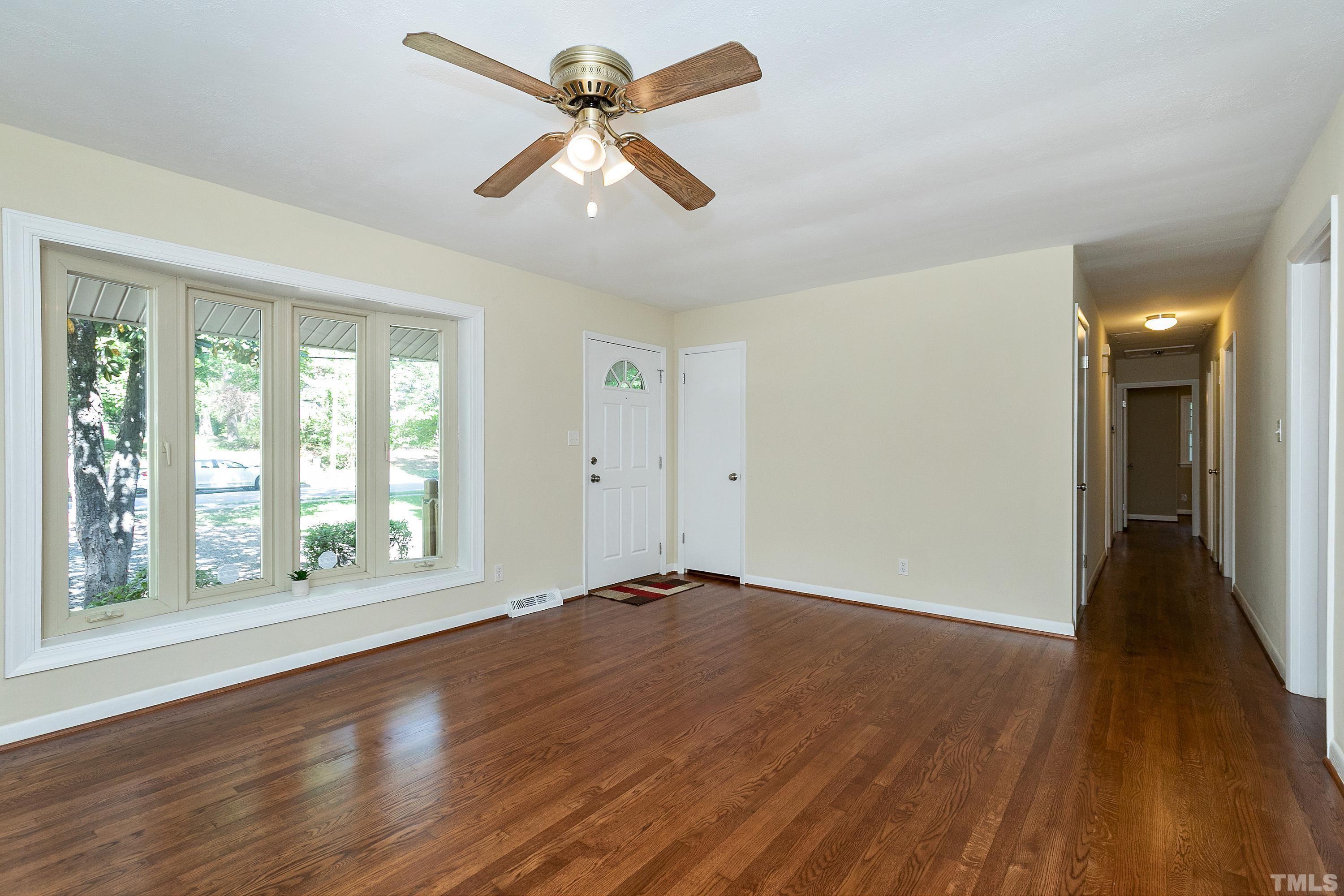 1721 Euclid Road Durham, NC 27713 - Photo 3 of 33 a view of an empty room with wooden floor and a window