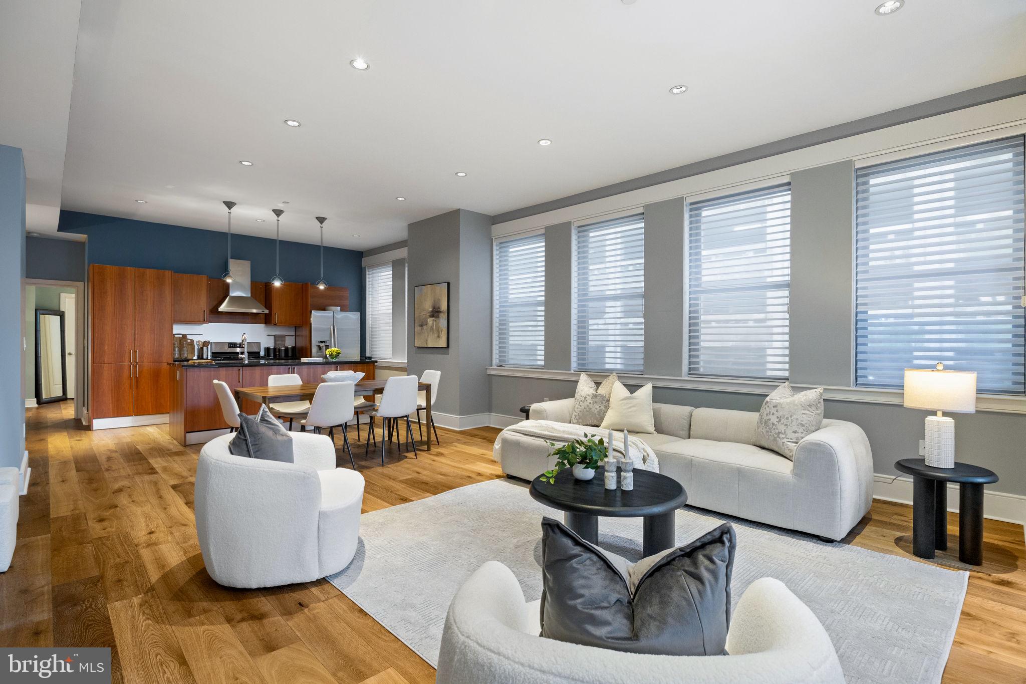 1515 Locust Street, Unit 401 Philadelphia, PA 19102 - Photo 12 of 35 a living room with furniture and floor to ceiling windows