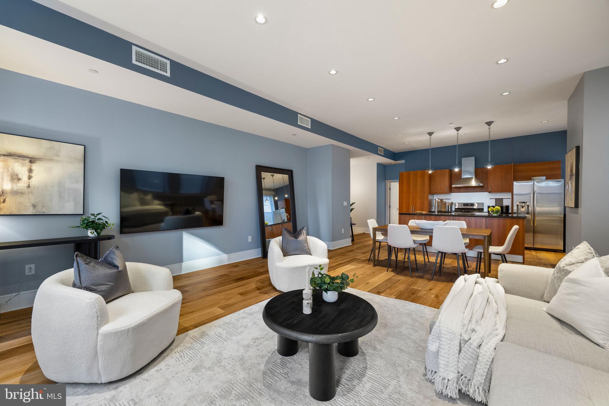 1515 Locust Street, Unit 401 Philadelphia, PA 19102 - Photo 14 of 35 a living room with furniture and a flat screen tv