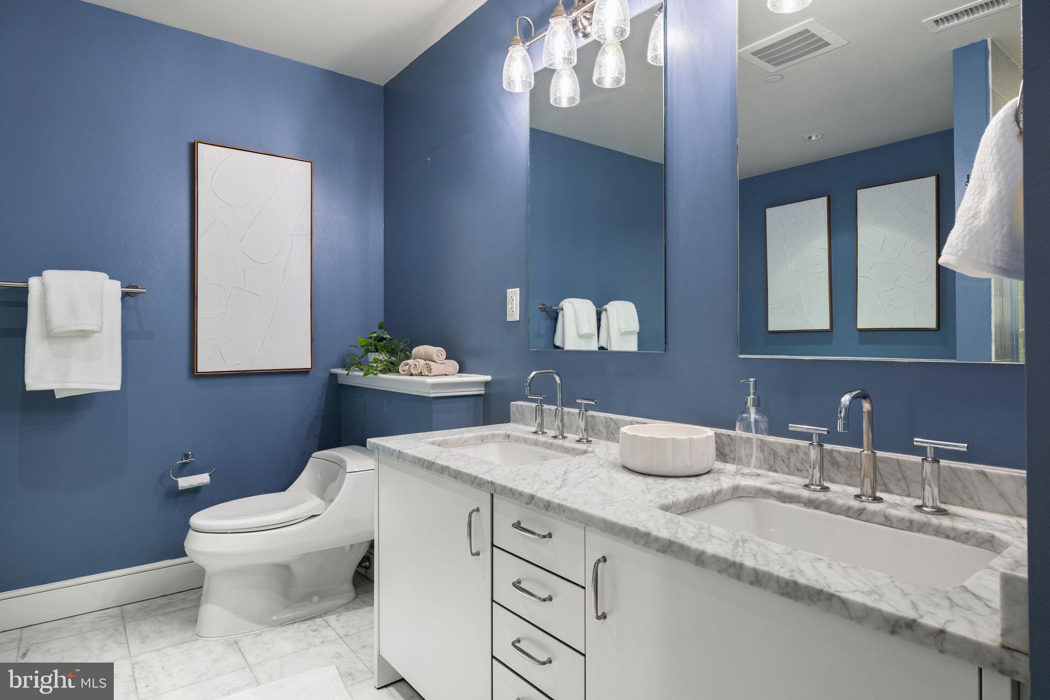 1515 Locust Street, Unit 401 Philadelphia, PA 19102 - Photo 20 of 35 a bathroom with a granite countertop toilet sink and mirror