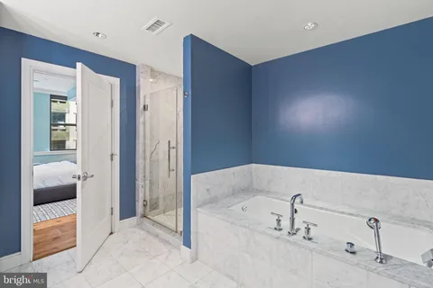 a bedroom with a bed and a couch