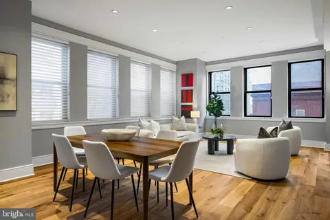 a kitchen with stainless steel appliances granite countertop wooden floors a stove a sink and a refrigerator