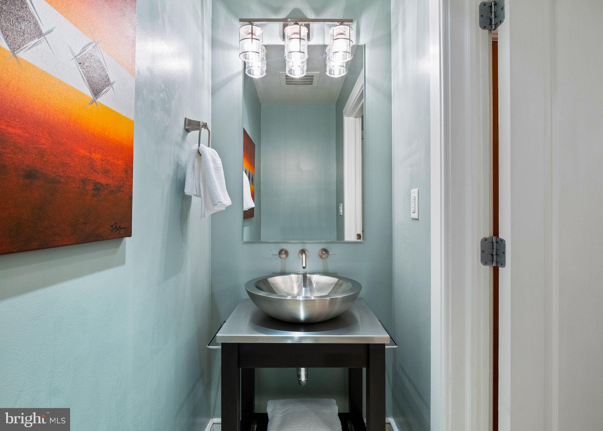 1515 Locust Street, Unit 401 Philadelphia, PA 19102 - Photo 32 of 35 a bathroom with a sink and a mirror