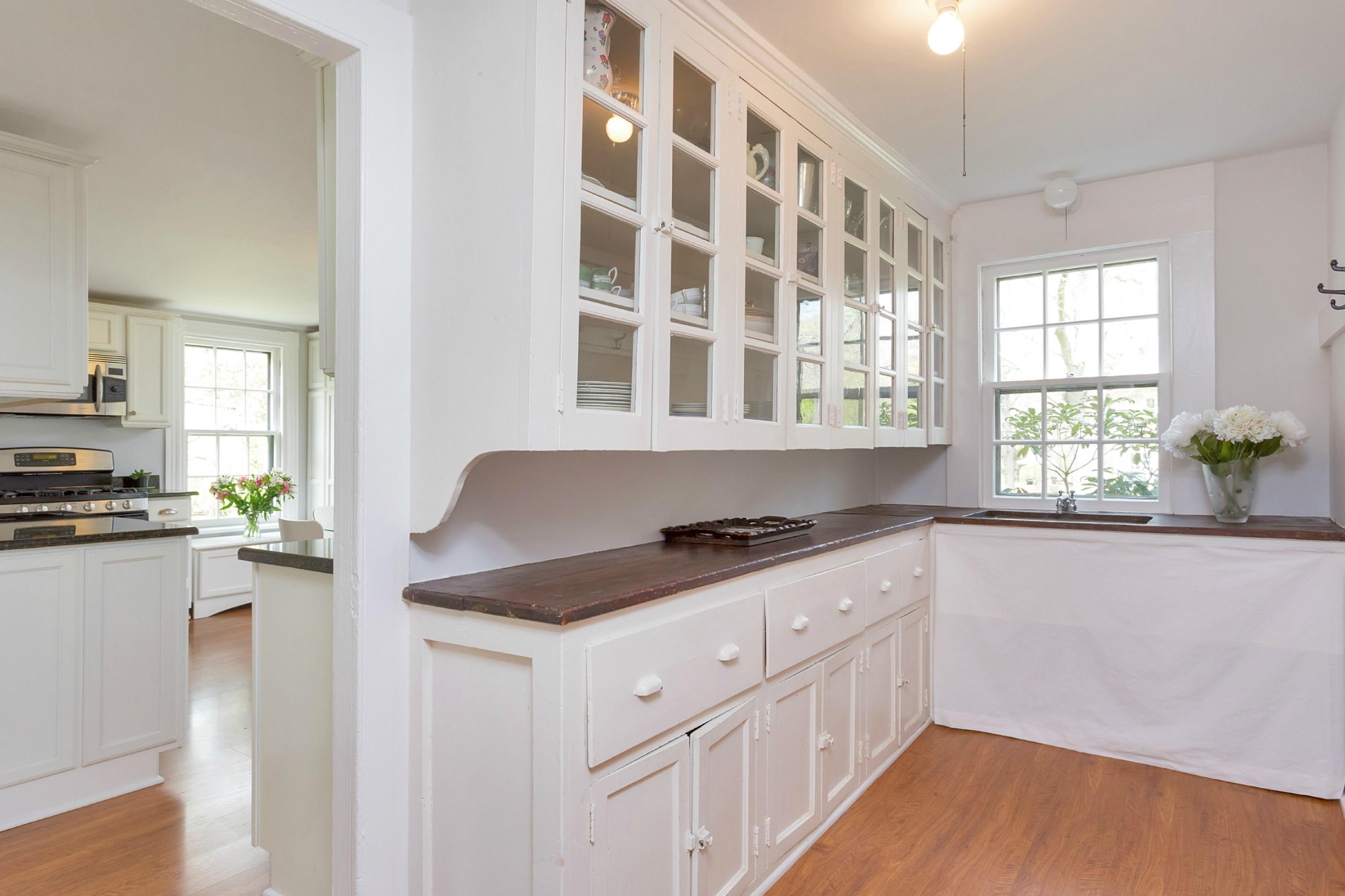 369 Middlesex Road Darien, CT 06820 - Photo 10 of 24 a kitchen with granite countertop a stove a sink and dishwasher wooden cabinets with wooden floor