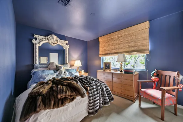 a bed room with a bed and a chair