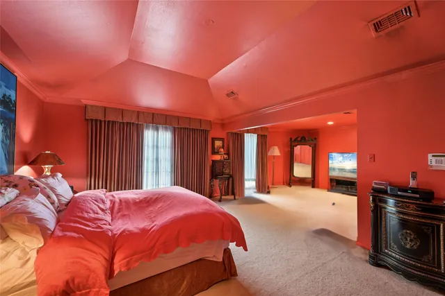 a large bedroom with a large bed and a large window