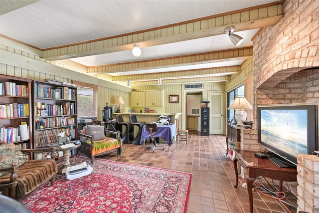 a living room with lots of furniture and a book shelf