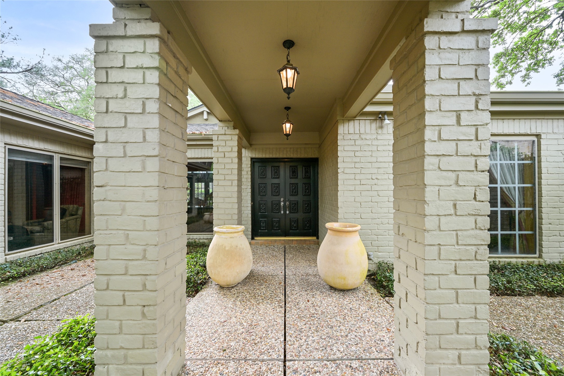 435 Flint Point Drive Piney Point Village, TX 77024 - Photo 5 of 32 a view of a brick house with potted plants