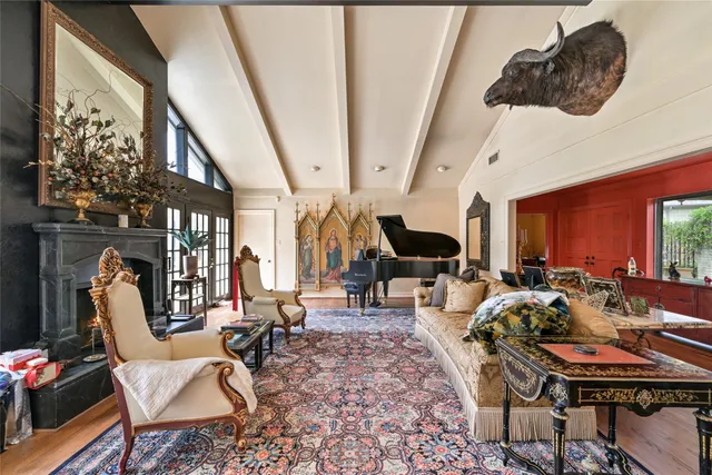a living room with furniture fireplace and a large window