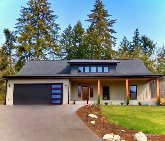 front view of a brick house with a yard