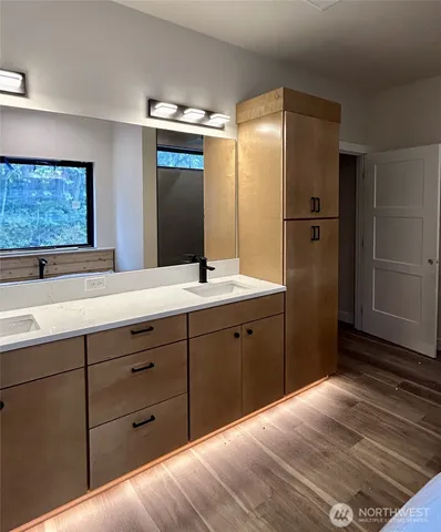 a spacious bathroom with a double vanity sink and mirror