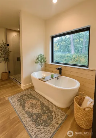 a spacious bathroom with a bathtub and shower