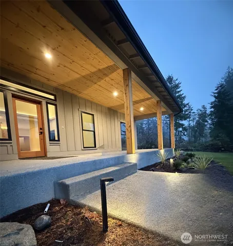 a view of a porch with furniture and floor to ceiling window