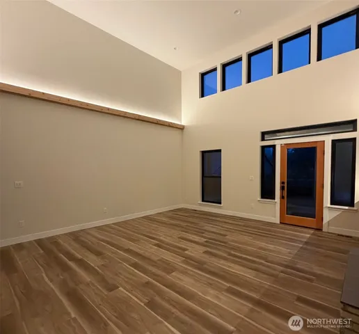 a view of an empty room with wooden floor