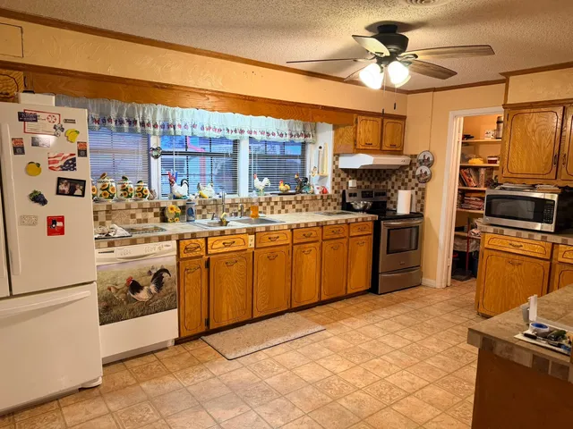 a kitchen with stainless steel appliances a stove a sink and a refrigerator