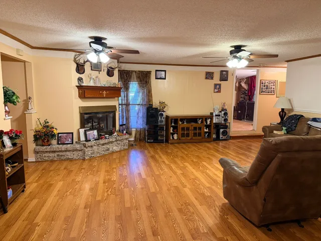 a view of a dining room with furniture a chandelier and wooden floor
