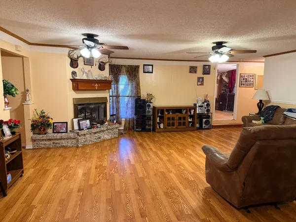 a view of a dining room with furniture a chandelier and wooden floor