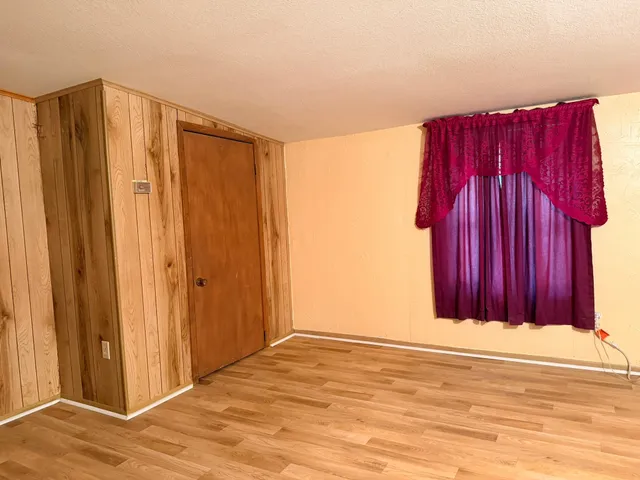 a view of a room with wooden walls