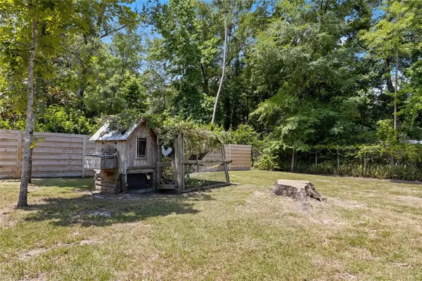 a view of a house with a yard and sitting area