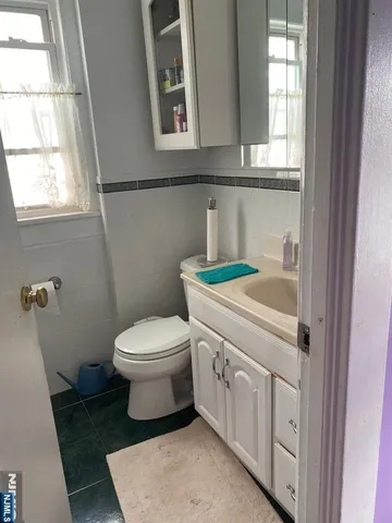 a bathroom with a sink a toilet and window
