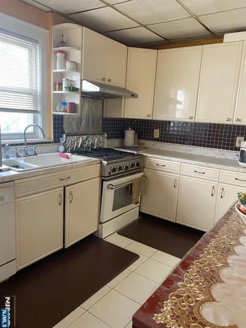 a kitchen with a stove a sink and a microwave