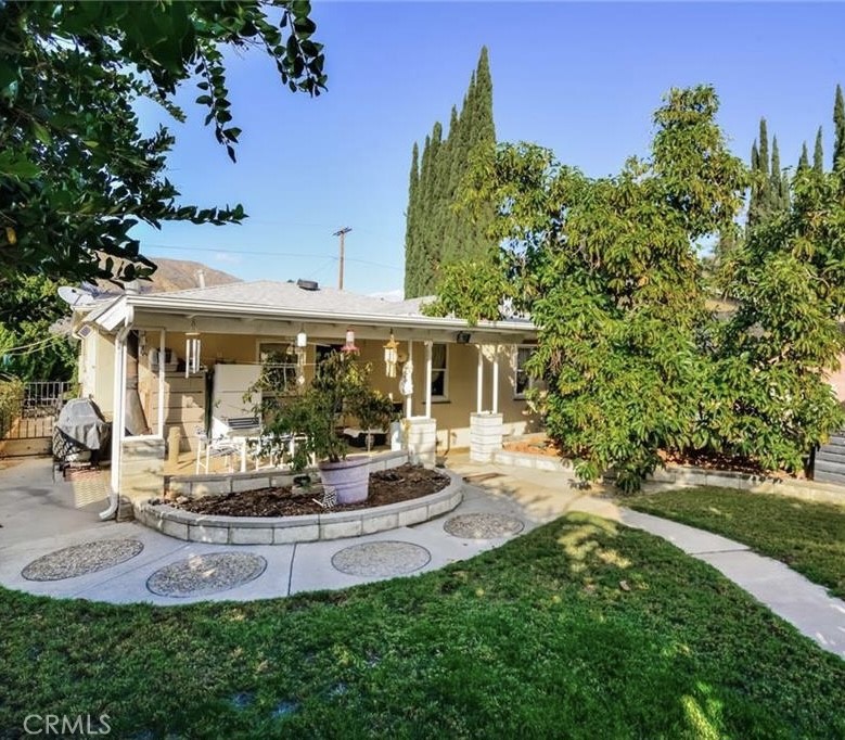a view of a house with backyard porch and sitting area