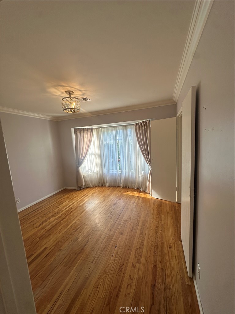 7918 Kyle Street Sunland, CA 91040 - Photo 3 of 18 wooden floor in an empty room with a window