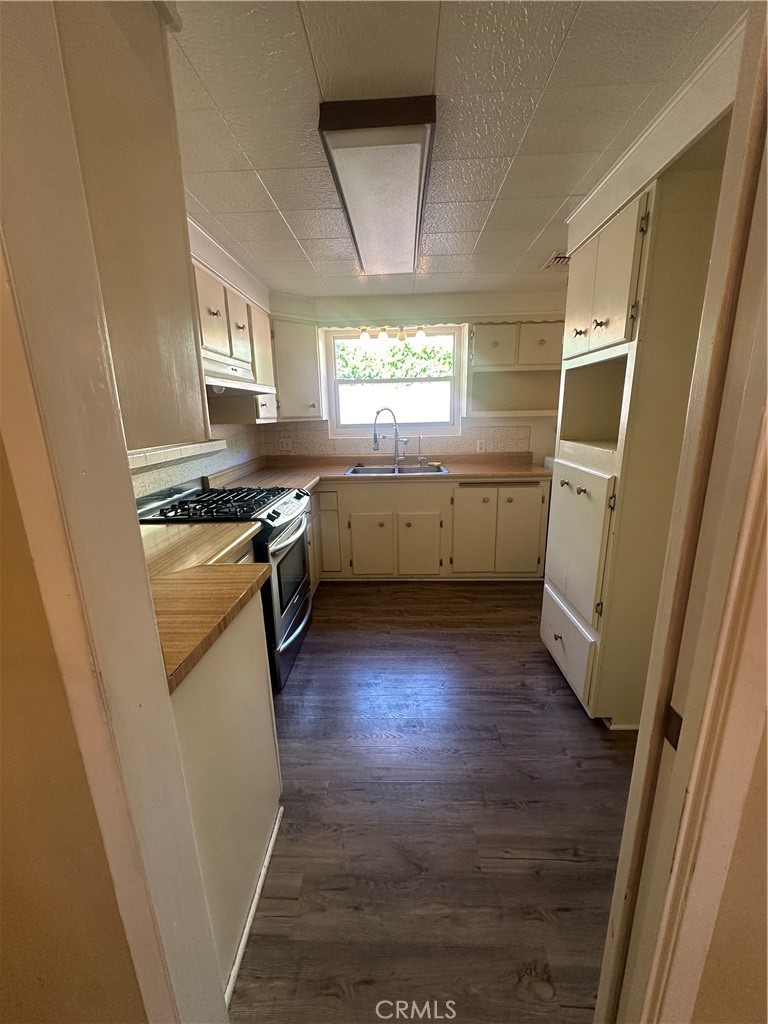 7918 Kyle Street Sunland, CA 91040 - Photo 5 of 18 a kitchen with a stove a sink and a refrigerator