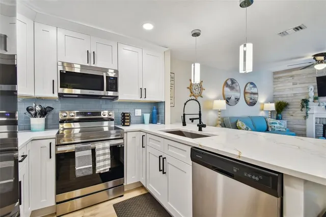 a kitchen with a stove and cabinets