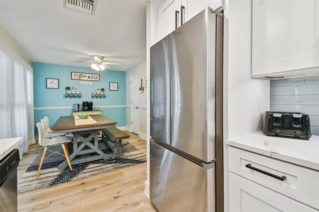a view of a kitchen with kitchen island a stove a sink and a refrigerator