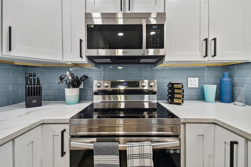 315 Medallion Boulevard, Unit E Madeira Beach, FL 33708 - Photo 18 of 78 a kitchen with a stove and cabinets