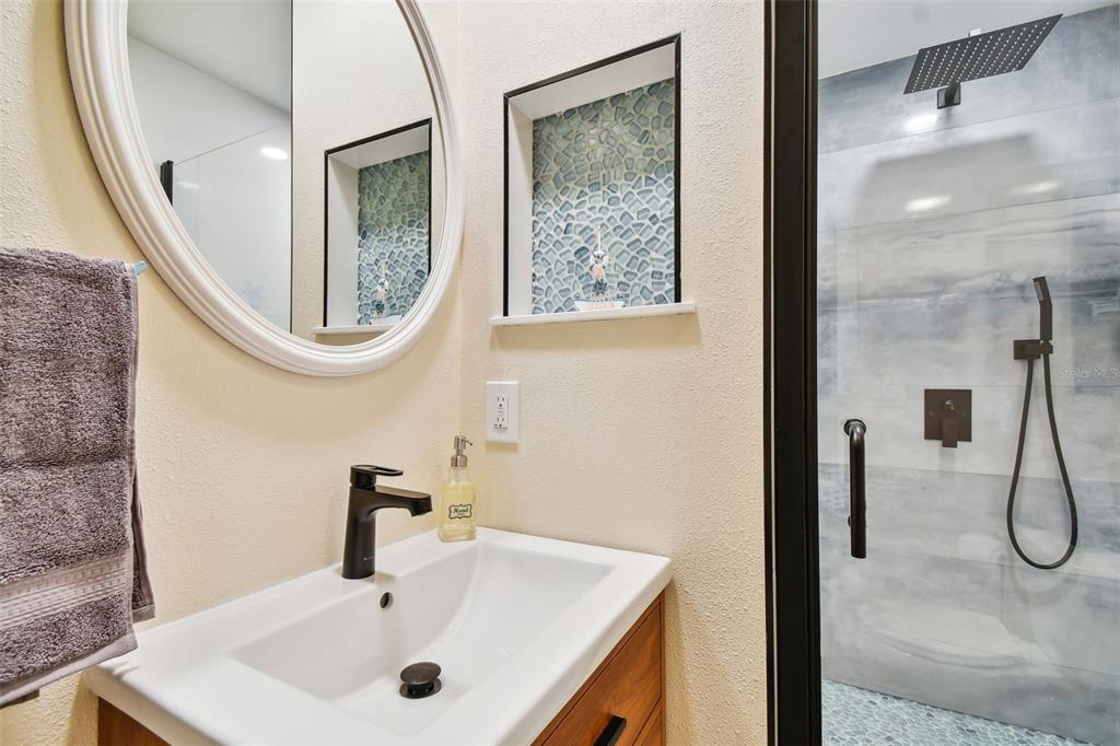 315 Medallion Boulevard, Unit E Madeira Beach, FL 33708 - Photo 26 of 78 a bathroom with a sink and a mirror
