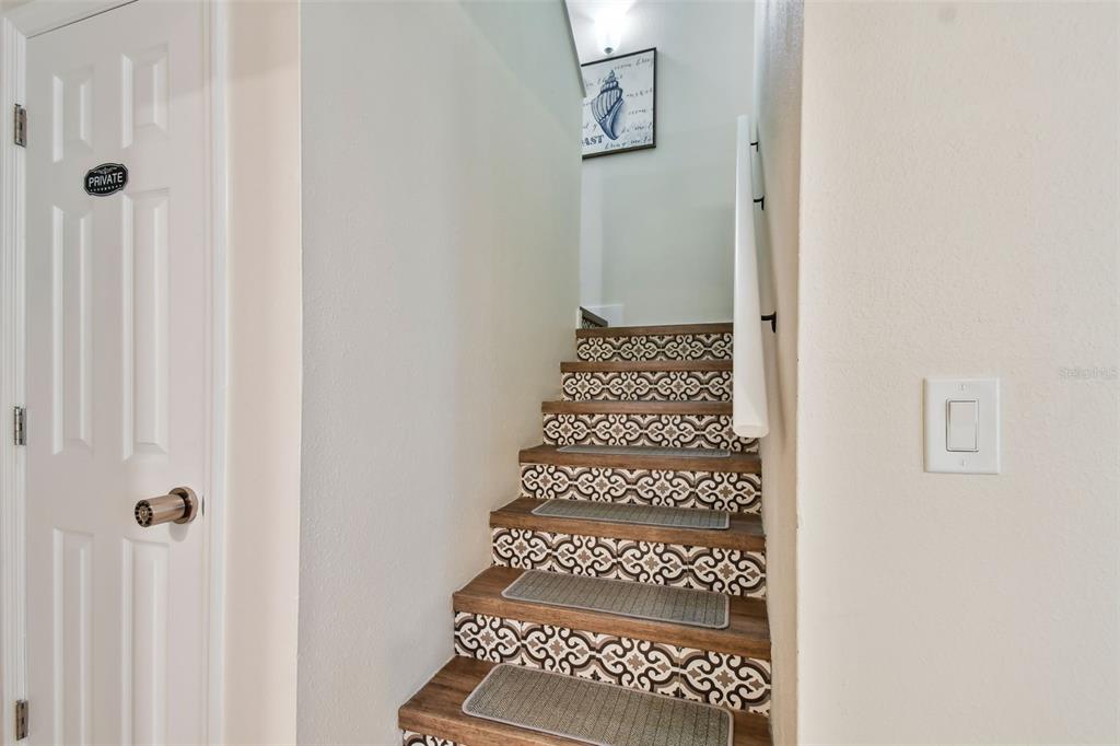 315 Medallion Boulevard, Unit E Madeira Beach, FL 33708 - Photo 31 of 78 a view of a room with white door and wooden floor