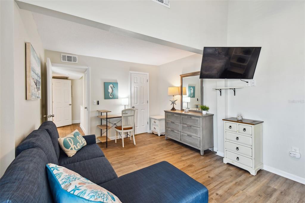 315 Medallion Boulevard, Unit E Madeira Beach, FL 33708 - Photo 45 of 78 a living room with furniture and a flat screen tv