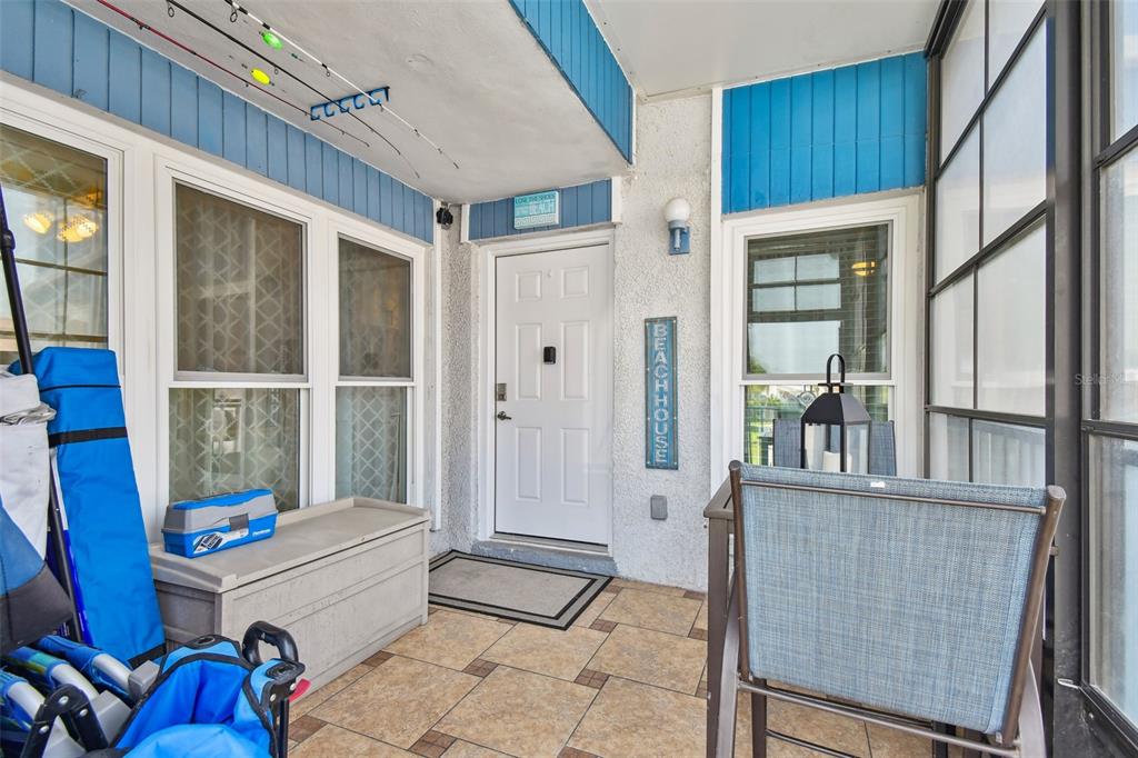 315 Medallion Boulevard, Unit E Madeira Beach, FL 33708 - Photo 47 of 78 a room with furniture a window and a glass door shower