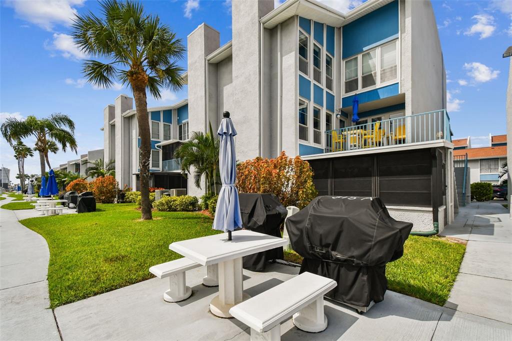 315 Medallion Boulevard, Unit E Madeira Beach, FL 33708 - Photo 51 of 78 a view of a patio in front of house