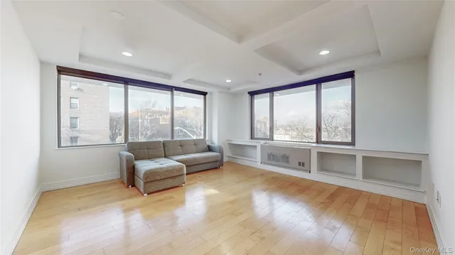 a living room with furniture and floor to ceiling windows