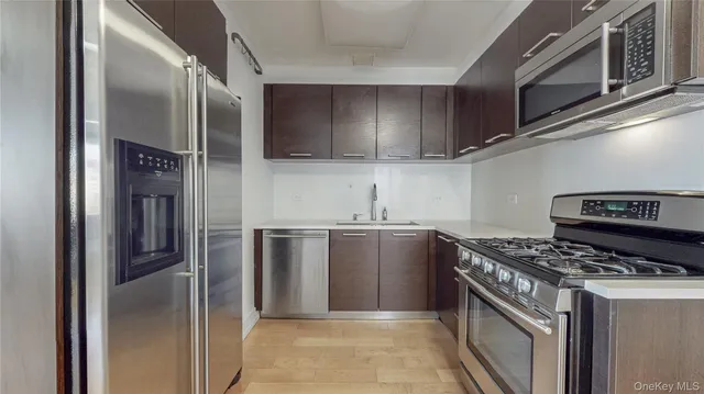 a kitchen with stainless steel appliances granite countertop a stove and a refrigerator
