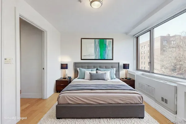 a bedroom with a large bed and a window